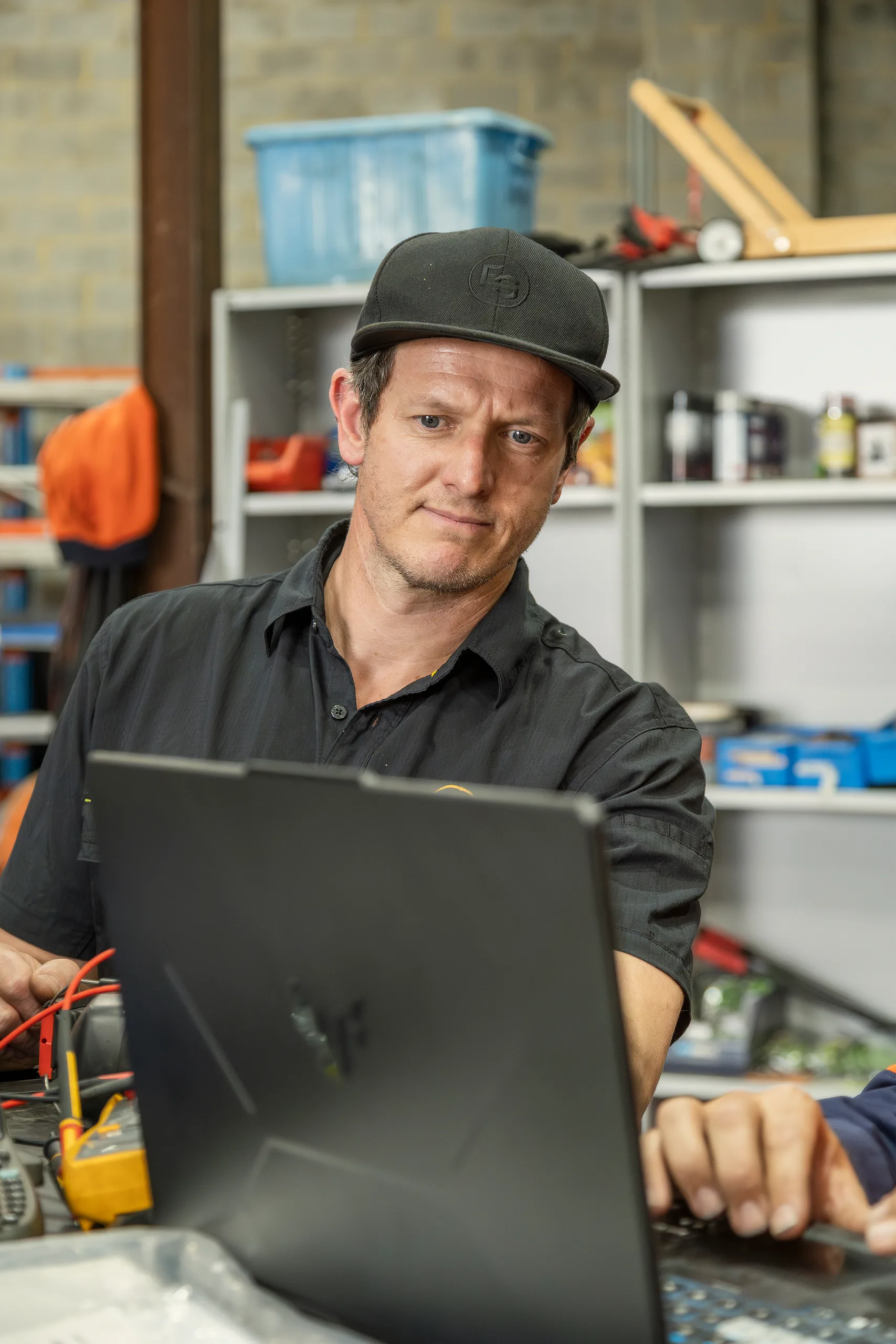 An Eastern Generators technician working at a laptop