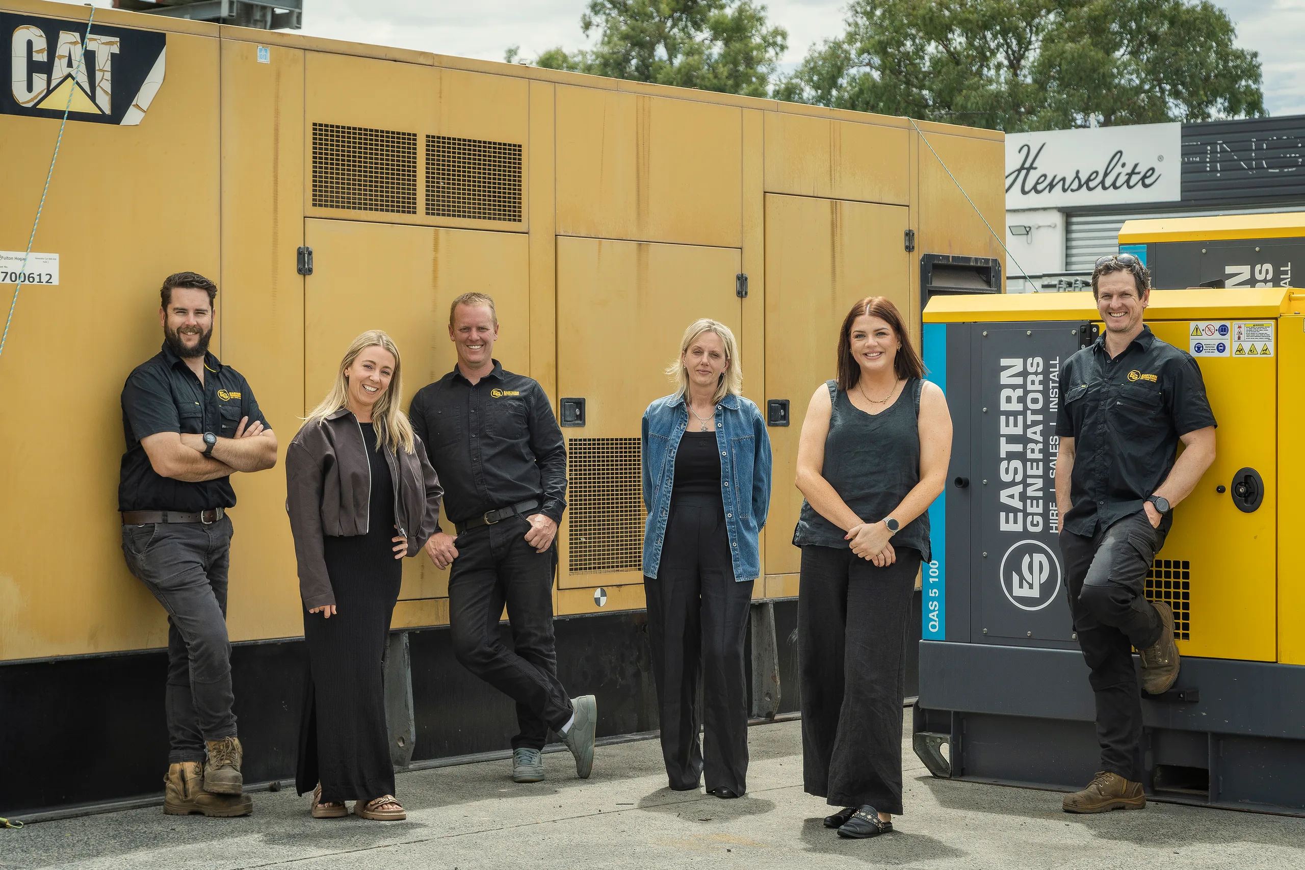 The Eastern Generators team beside a CAT generator on a client site