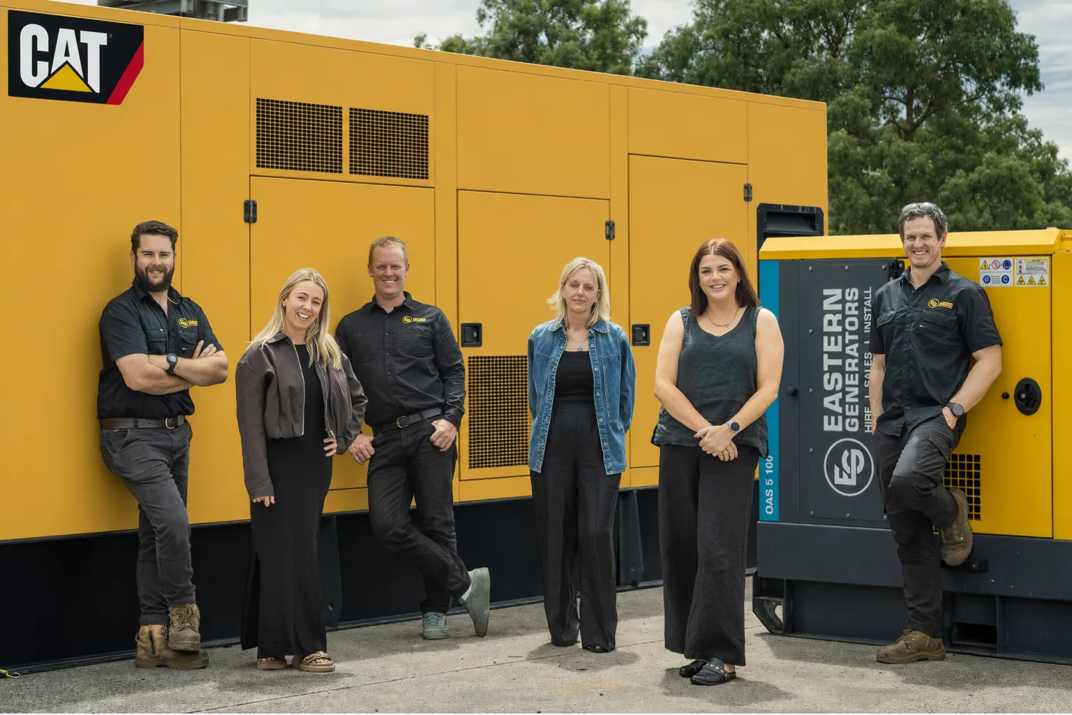 The Eastern Generators team in front of a large CAT generator unit
