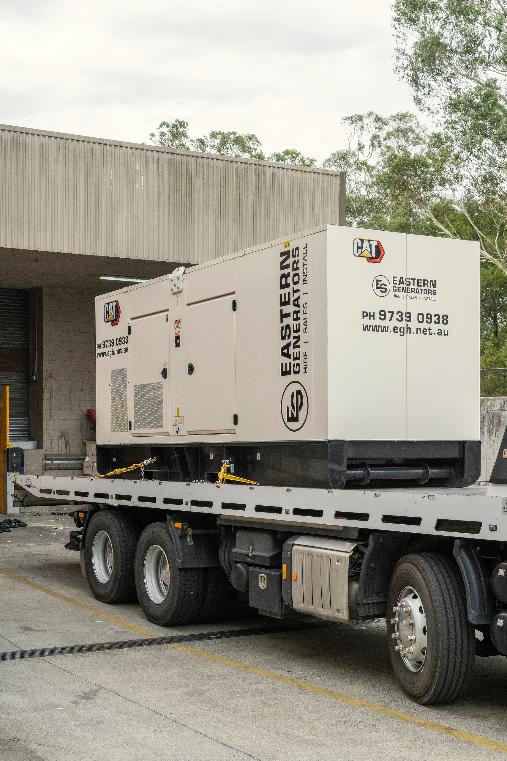 A canopied CAT generator branded Eastern Generators on a delivery truck