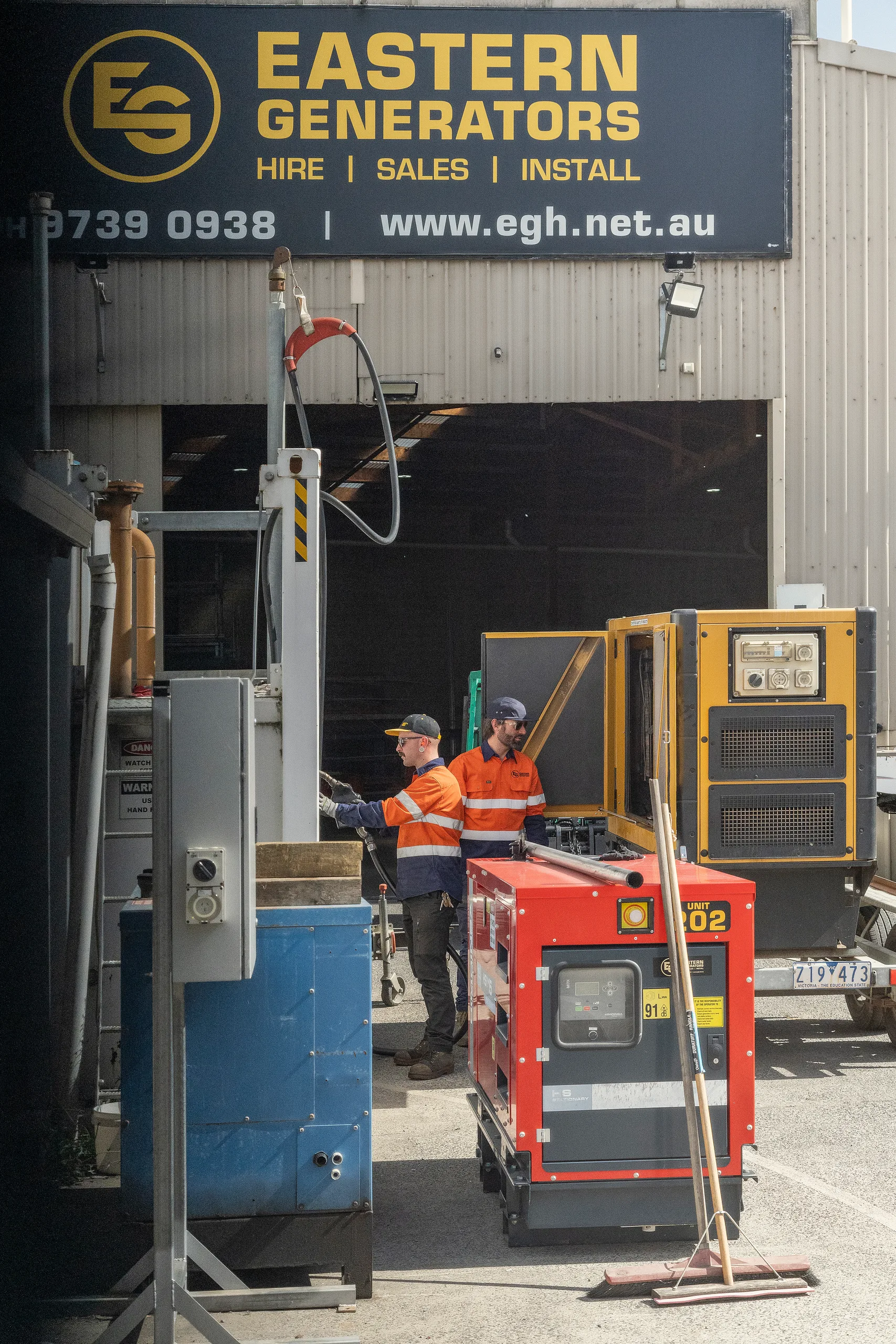 An Eastern Generators crew working on generators outside an industrial building