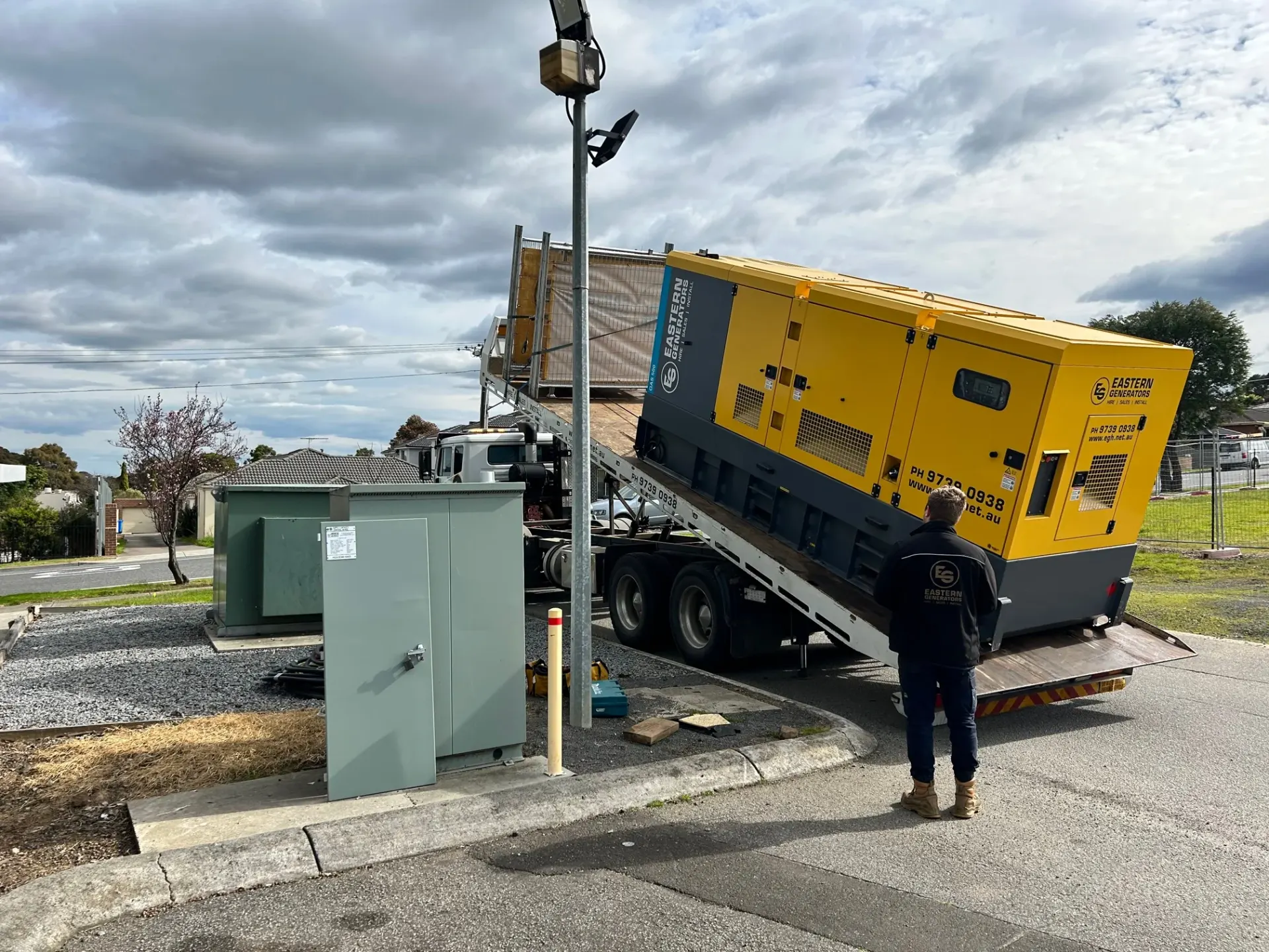 A hire generator placed beside a street supply pillar during a network shutdown