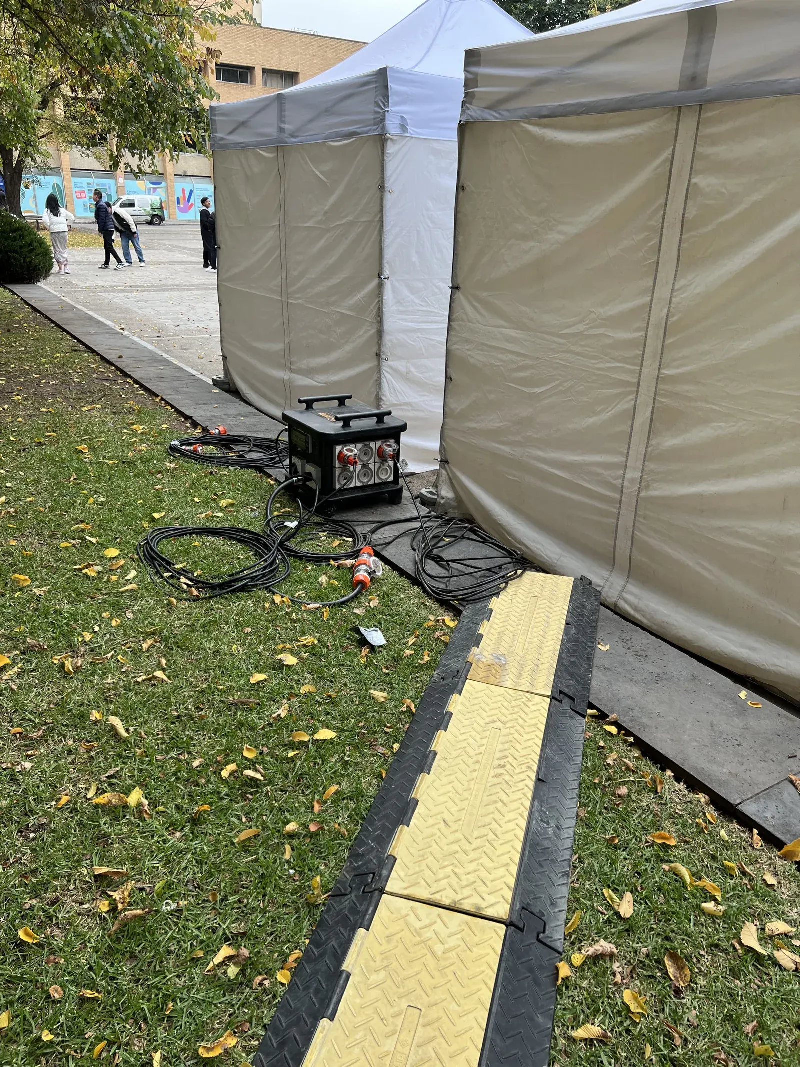 A portable generator powering marquees at an outdoor event