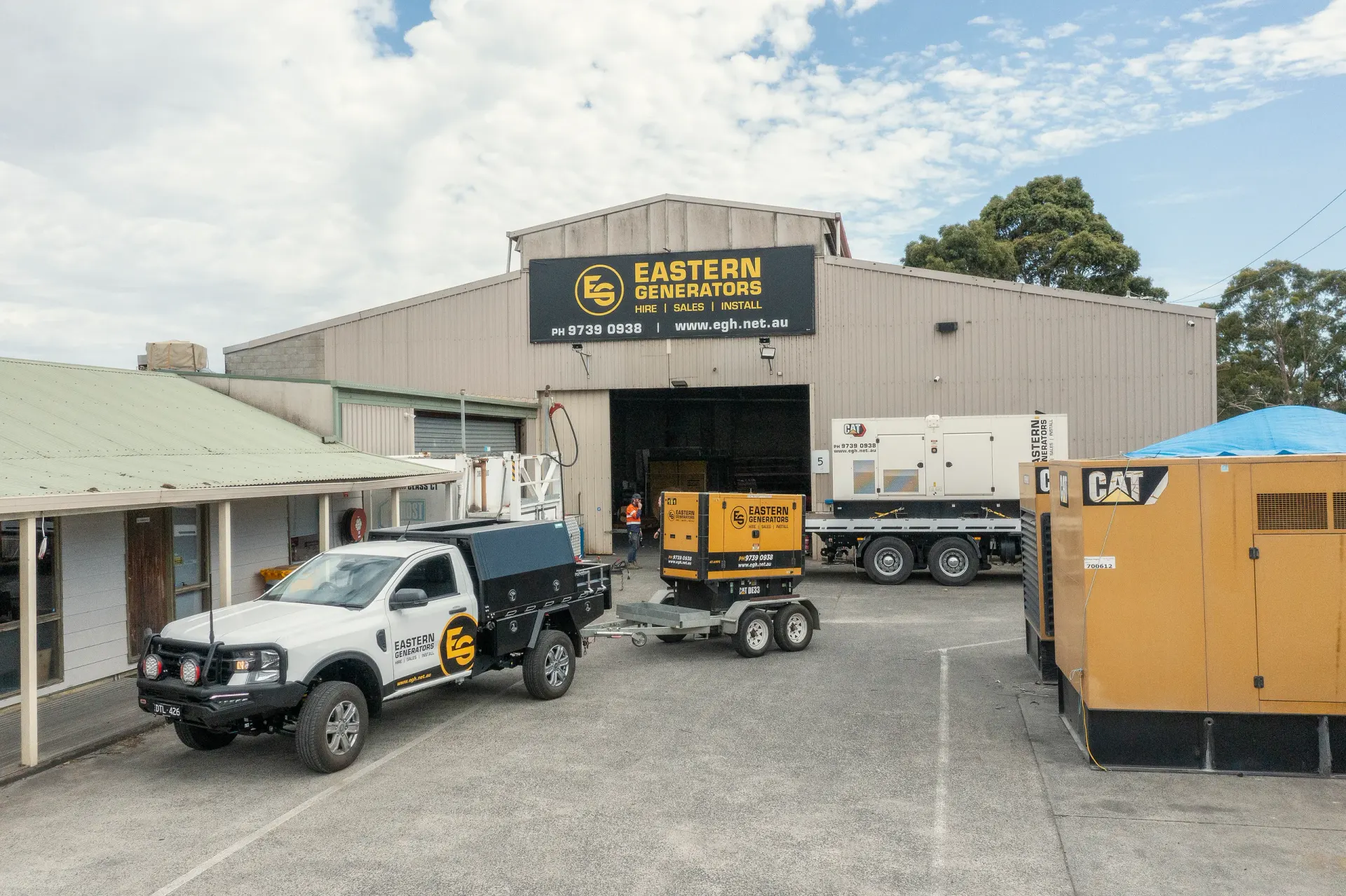 A small Eastern Generators hire set on a trailer behind a branded ute at the Kilsyth yard