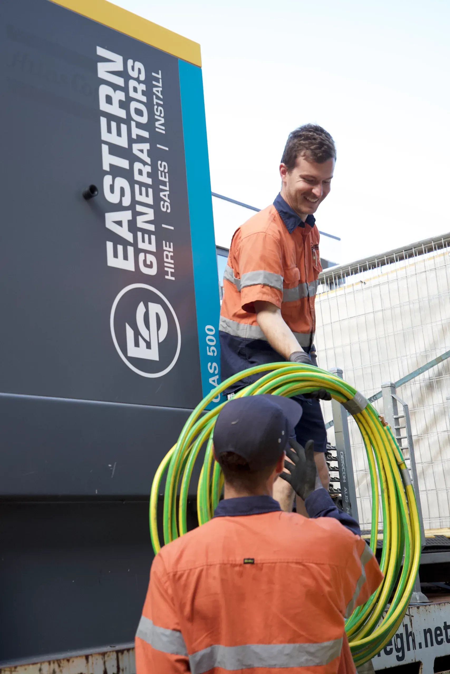 An Eastern Generators technician running earth cable to a large hire set