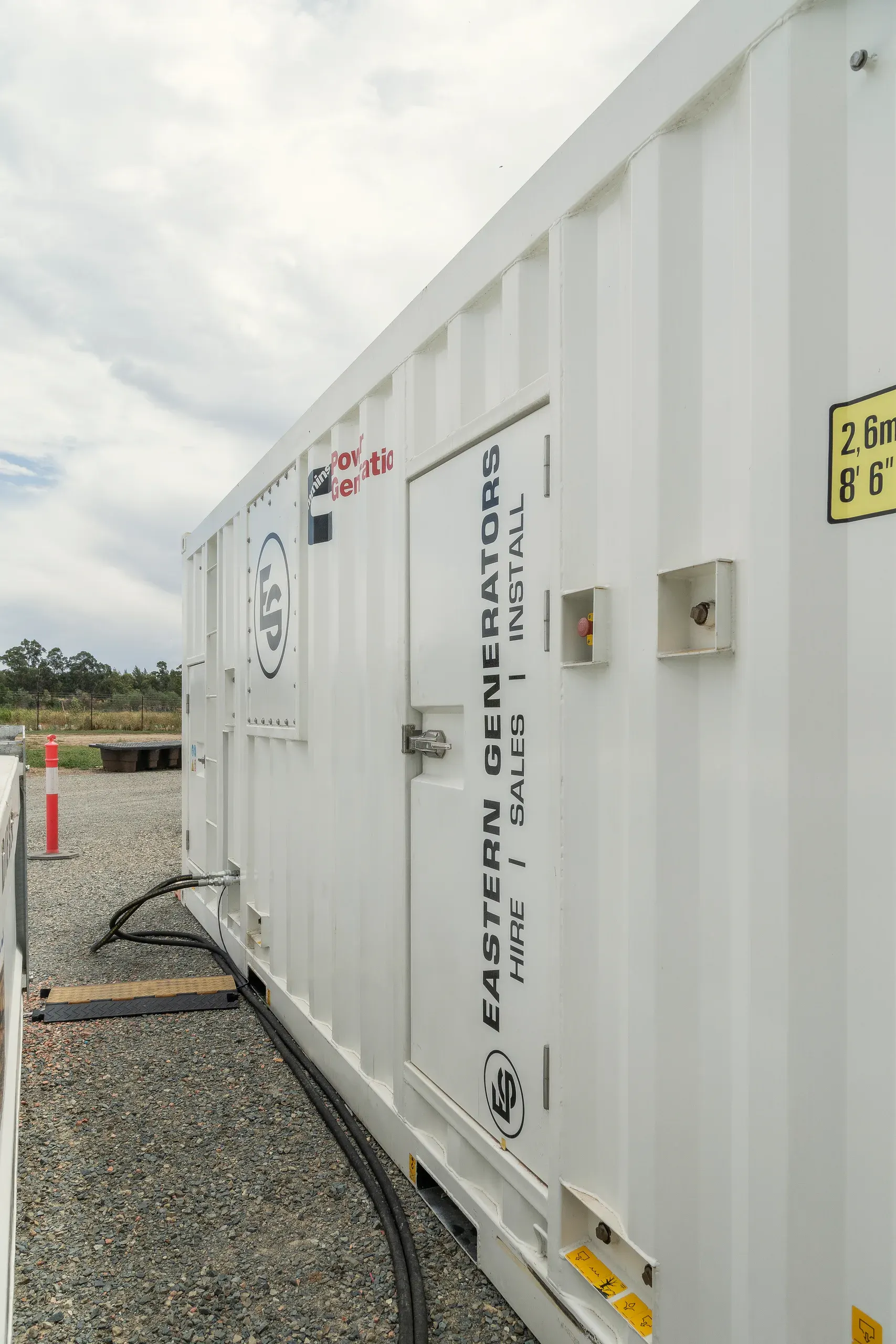 A containerised Eastern Generators hire unit standing on site